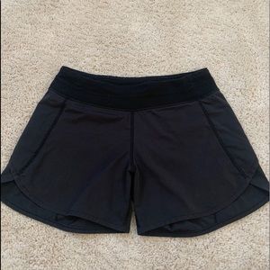 Black Ivivva athletic shorts.